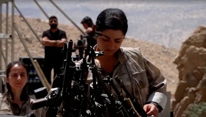 Kurdish PKK militants burn weapons in Iraq to mark step towards peace