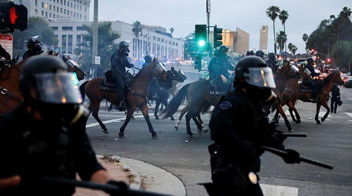 Scuffles in Los Angeles as soldiers sent by Trump fan out